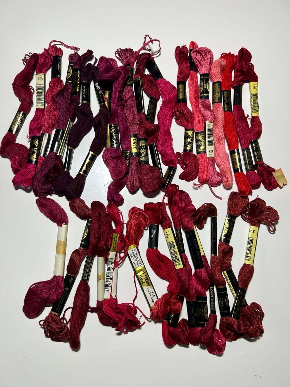 35 Skeins of cranberry, red , maroon, embroidery thread DMC